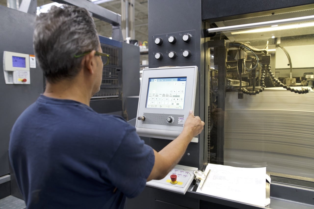 A worker operating a machine in a factory